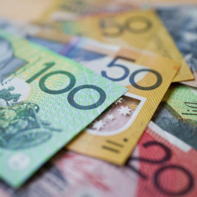 Australian currency piled up going from $100 bill downwards in denominations